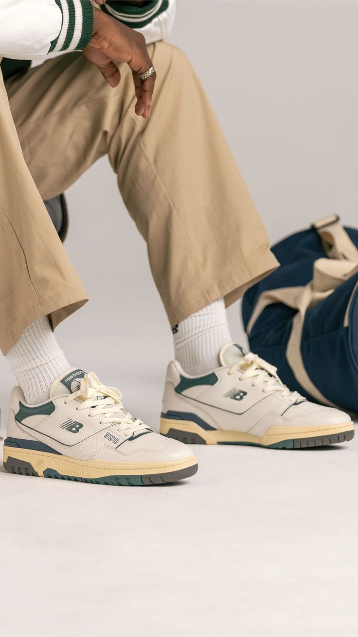 New Balance sneakers styled with relaxed trousers and a varsity jacket